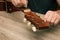 Hands of a young man changing the string on an acoustic guitar. Hand fixing guitar