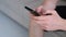 hands of a young man chatting on smartphone. Extreme close-up hands of unrecognizable man typing online message using