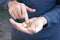 Hands of a young man close-up, counting a trifle, iron coins money of Ukraine