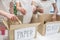 Hands of young people sorting paper and glass