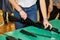 Hands of young person is dismantling a weapon. Teenager collects a Kalashnikov assault rifle on the table during war lesson