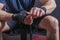 Hands of young and strong mixed martial arts fighter who wraps black protective elastic bandage around his fists