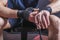 Hands of young and strong mixed martial arts fighter who wraps black protective elastic bandage around his fists