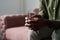 Hands of young troubled African American man holding glass of water