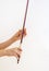 Hands of a young violinist rosin his bow on the background of a piano illuminated by the sun, vertical