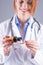 Hands of young woman doctor pouring medicinal syrup on spoon