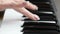 Hands of a young woman playing piano