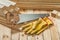 Handsaw and yellow working gloves on wooden timber materials