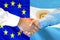 Handshake on Argentina and European Union flag background