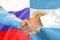 Handshake on Argentina and Russia flag background