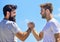 Handshake arm wrestling style. Strong and muscular arms. Successful deal handshake blue sky background. Men shaking