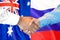 Handshake on Australia and Russia flag background