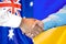 Handshake on Australia and Ukraine flag background