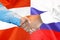 Handshake on Austria and Russia flag background