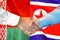 Handshake on Belarus and North Korea flag background. Support concept