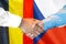 Handshake on Belgium and Czech Republic flag background