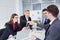 Handshake business people. A group of businessmen at desk in mo