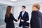 Handshake business people. A group of businessmen at desk in mo