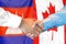 Handshake on Cambodia and Canada flag background. Support concept