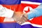 Handshake on Cambodia and North Korea flag background. Support concept