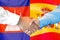 Handshake on Cambodia and Spain flag background. Support concept