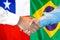 Handshake on Chile and Brazil flag background