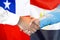 Handshake on Chile and Egypt flag background