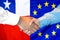 Handshake on Chile and European Union flag background