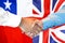 Handshake on Chile and UK flag background