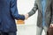 Handshake between client and Manager on the background of the office