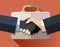 Handshake of corrupt business men on a briefcase background.