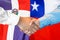 Handshake on Dominican Republic and Chile flag background. Support concept