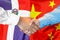 Handshake on Dominican Republic and China flag background. Support concept