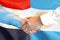 Handshake on Egypt and Argentina flag background