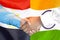 Handshake on Egypt and India flag background