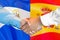 Handshake on El Salvador and Spain flag background. Support concept