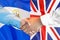 Handshake on El Salvador and UK flag background. Support concept