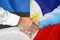 Handshake on Estonia and Philippines flag background. Support concept