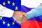Handshake on European Union and Russia flag background
