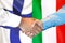 Handshake on Finland and Italy flag background