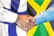 Handshake on Finland and Jamaica flag background