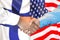 Handshake on Finland and US flag background