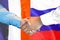 Handshake on France and Russia flag background