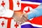 Handshake on Georgia and North Korea flag background
