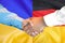 Handshake on Germany and Ukraine flag background