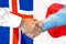 Handshake on Iceland and Japan flag background