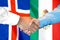 Handshake on Iceland and Mexico flag background