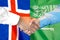 Handshake on Iceland and Saudi Arabia flag background