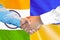 Handshake on India and Ukraine flag background