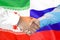 Handshake on Iran and Russia flag background